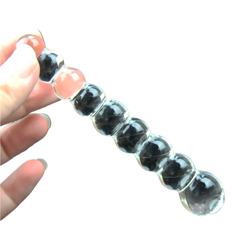 a transparent, segmented glass or acrylic anal beads with a series of rounded, bubble-like shapes.