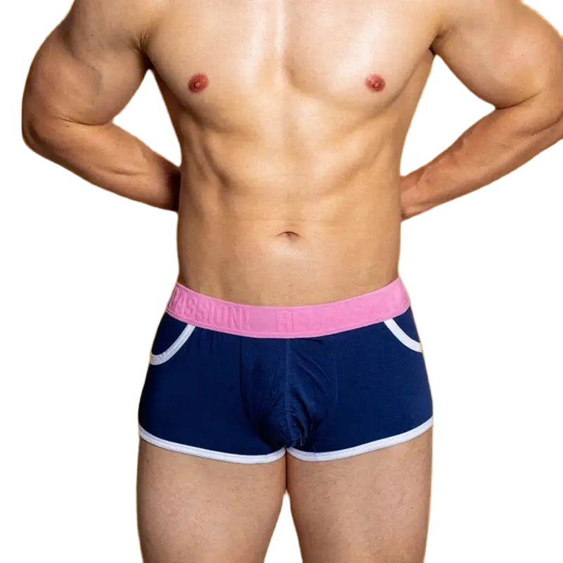 Navy swim shorts with pink waistband and white trim on a plain background