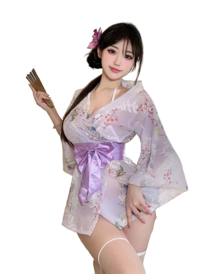 Woman in a floral kimono with a purple ribbon sitting on a couch.