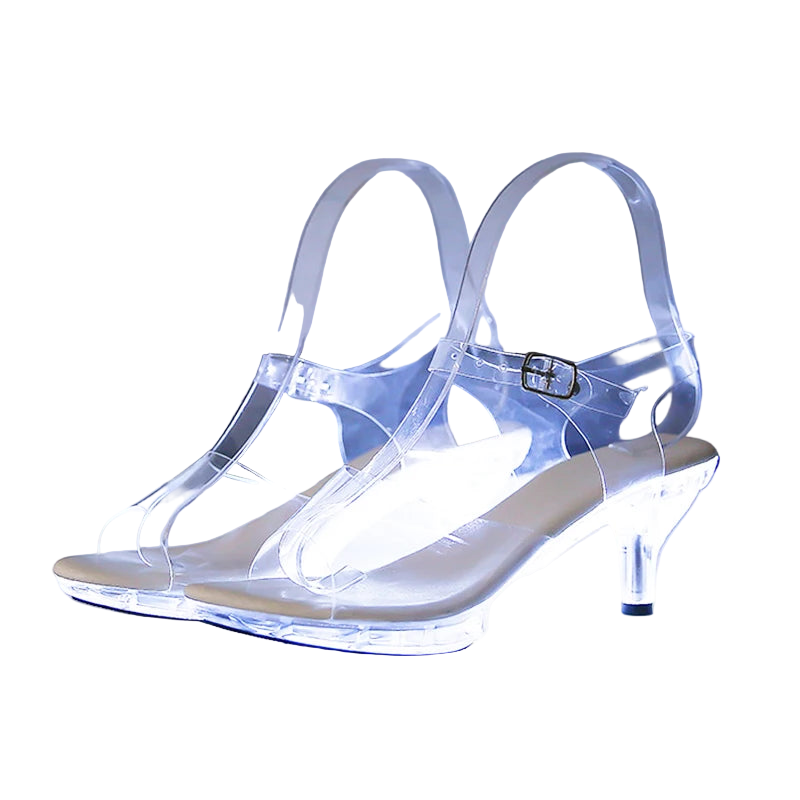 Clear high-heeled shoes with measurements on a reflective surface