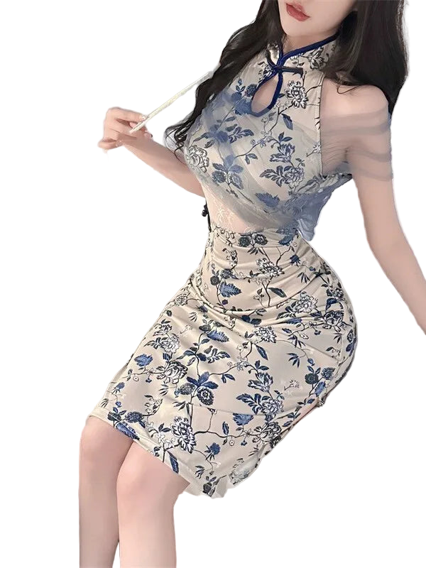 Woman wearing a floral dress sitting on a bed