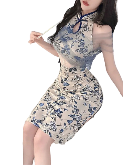 Woman wearing a floral dress sitting on a bed