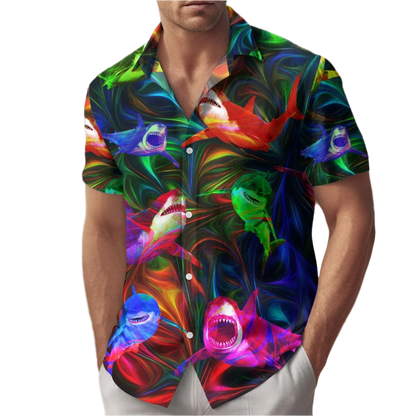 Man wearing a colorful shark pattern shirt on a beach