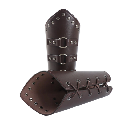 Pair of brown leather arm guards with metal studs and buckles on a white background