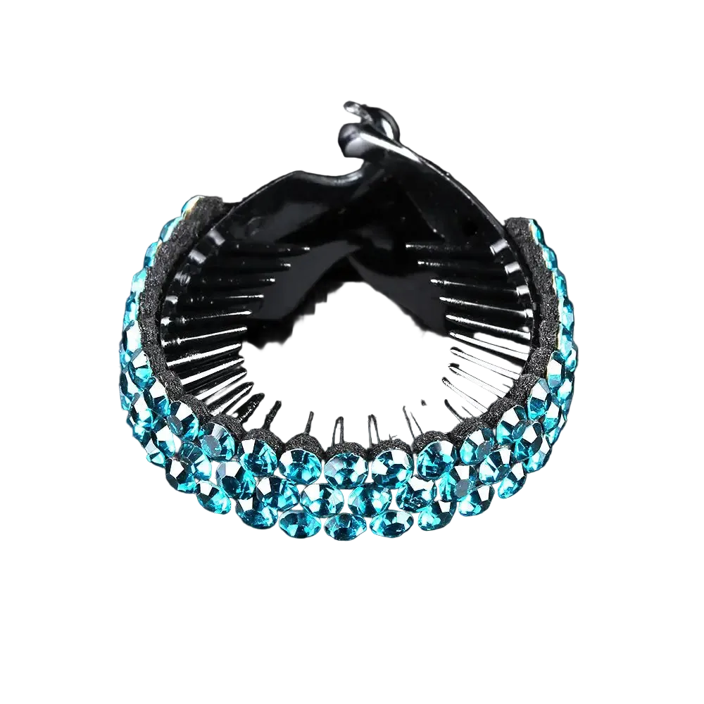 A black hair claw clip embellished with a row of faceted light blue rhinestones on the front, shown on a reflective black background.