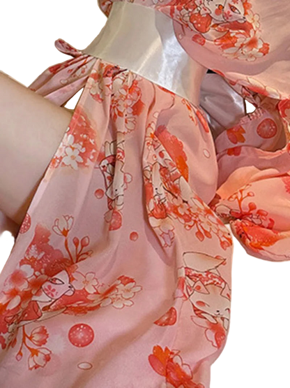 Close-up of a floral dress with pink and orange flowers on a white background