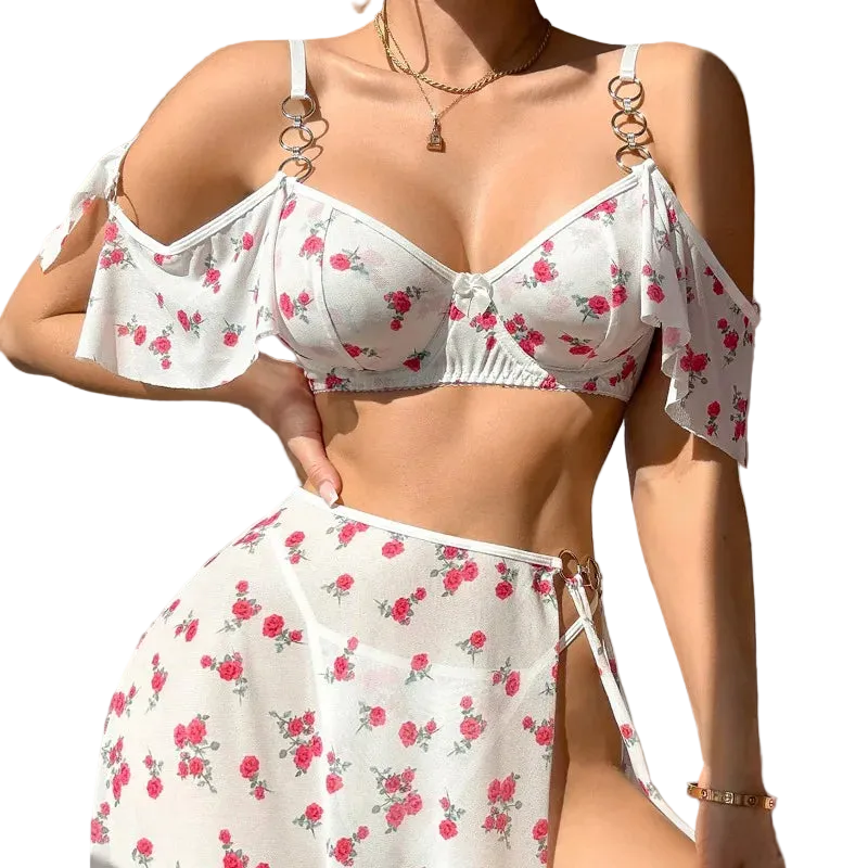 Woman wearing a white floral bikini set against a neutral background