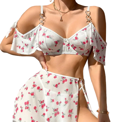 Woman wearing a white floral bikini set against a neutral background