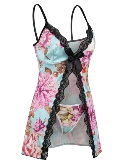 A floral print babydoll lingerie chemise with black lace trim, black spaghetti straps, and a black bow at the neckline, shown on a plain white background.