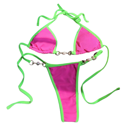 A two tone bikini with chain details. The design is sleek and modern, with a touch of edginess from the metallic accents.
