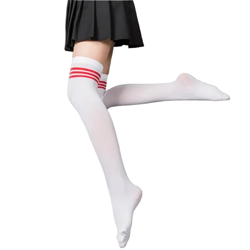 Person wearing white thigh-high socks with red stripes sitting on a gray couch.