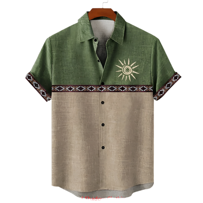 Green and beige shirt with sun design on a hanger against a white background