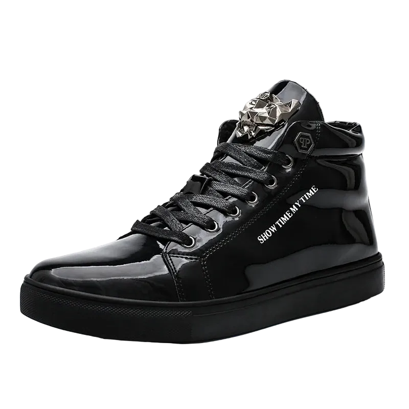 A black high-top sneaker with a glossy patent leather finish, featuring a silver metallic decorative buckle on the tongue, black laces, and white text reading 'SHOW TIME. IN TIME' on the side.