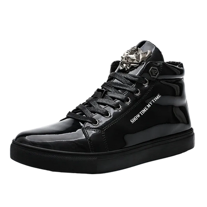 A black high-top sneaker with a glossy patent leather finish, featuring a silver metallic decorative buckle on the tongue, black laces, and white text reading 'SHOW TIME. IN TIME' on the side.