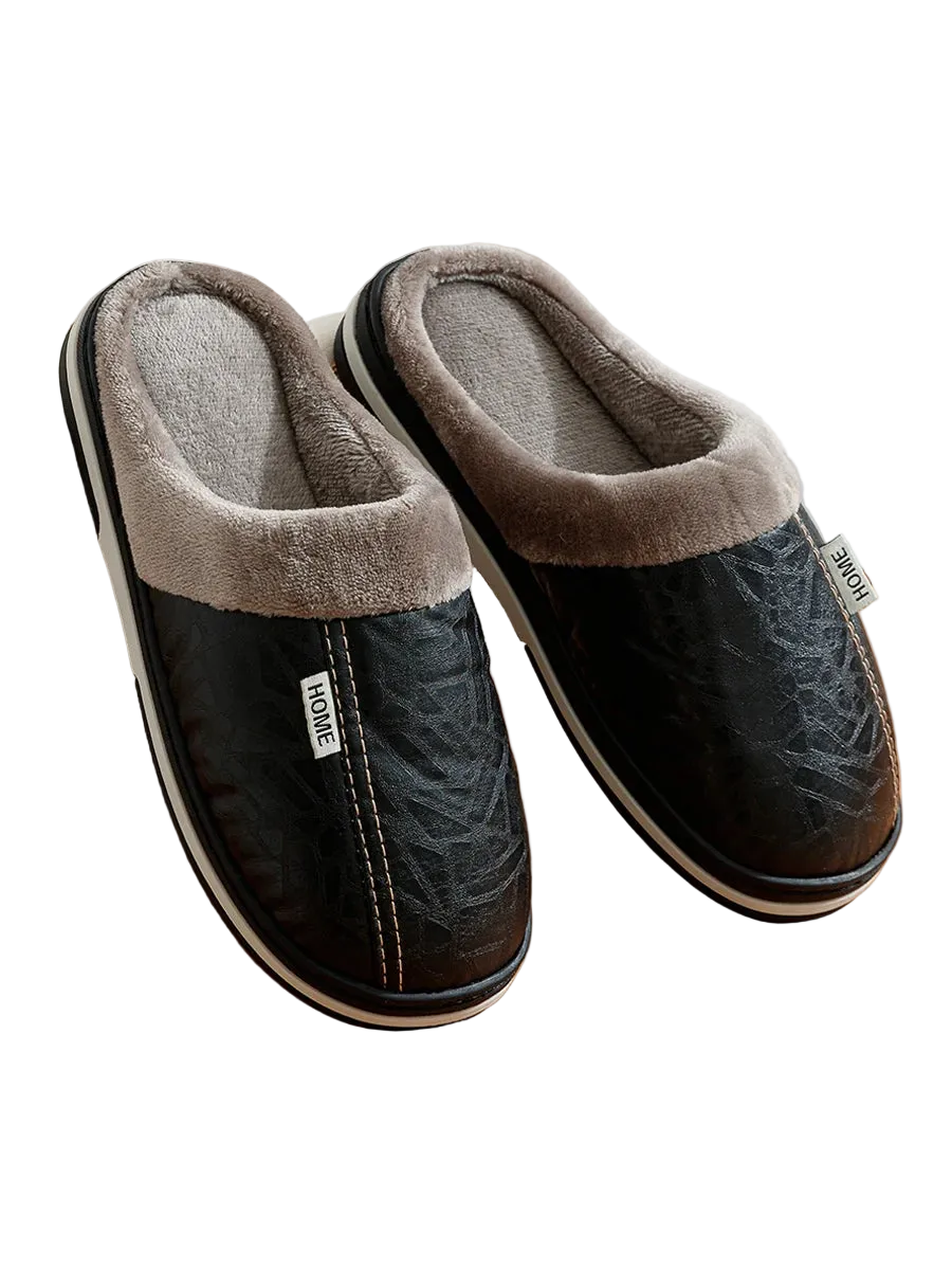 Pair of black and gray slippers on a wooden surface with a blurred background