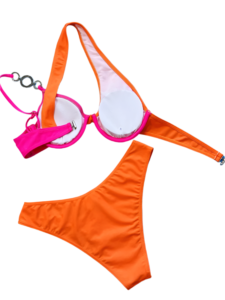 A two-tone bikini with orange and pink sections, featuring asymmetrical straps and jeweled embellishments. The design is vibrant and unique, perfect for a standout beach look.