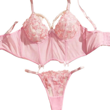 Pink lingerie set with floral details on a light background