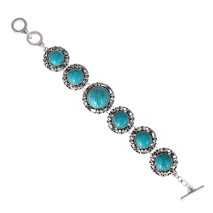 Turquoise stone bracelet with silver accents on a white background