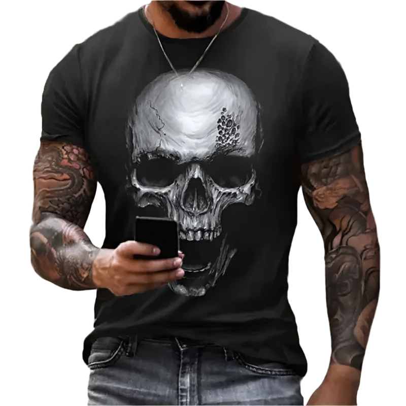 Person wearing a black t-shirt with a skull design, holding a phone.