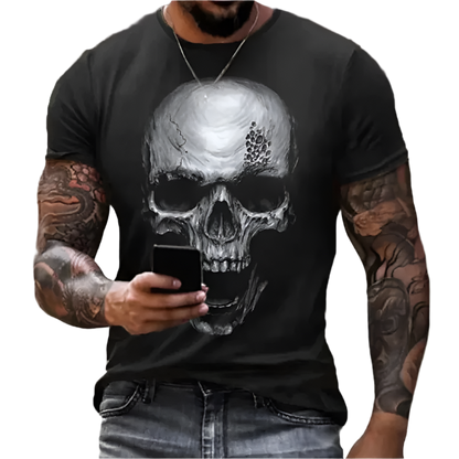 Person wearing a black t-shirt with a skull design, holding a phone.