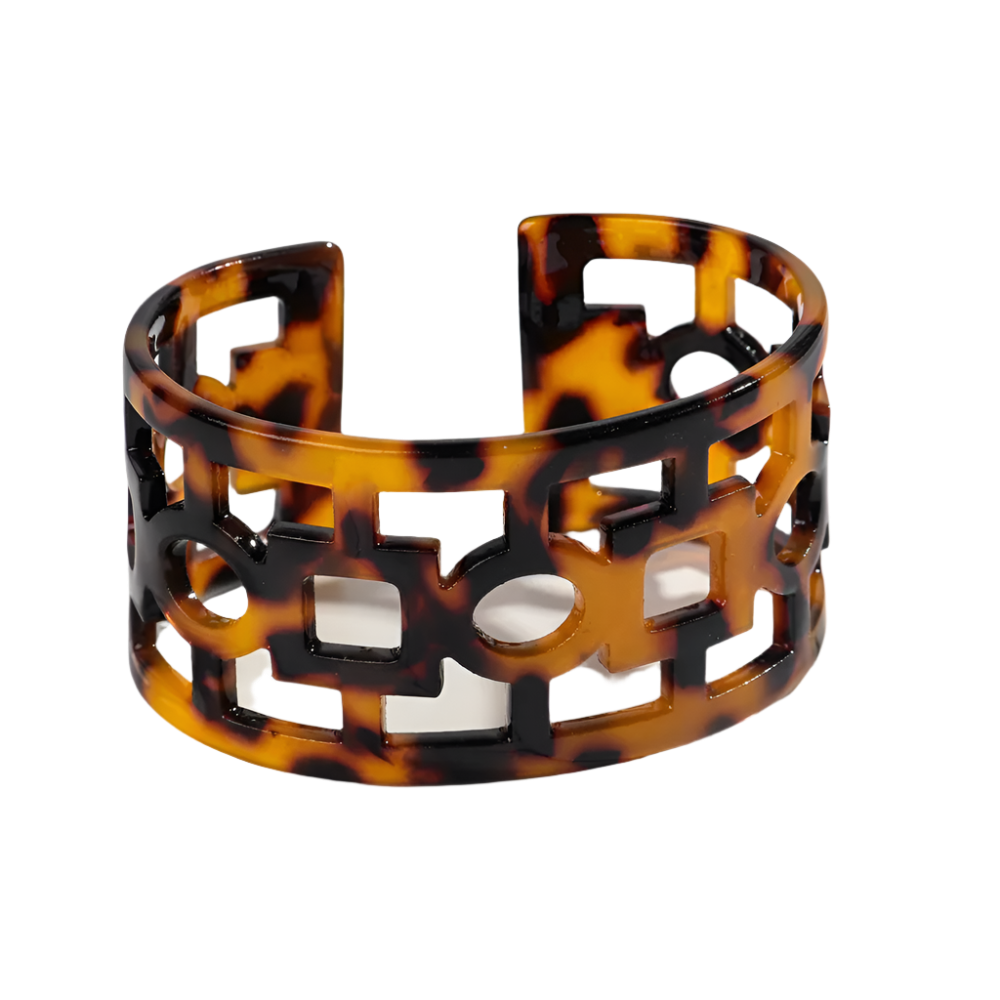 Bold leopard print wide cuff bangle featuring hollow geometric patterns and premium resin design for resort wear and theme nights

