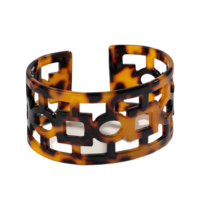 Bold leopard print wide cuff bangle featuring hollow geometric patterns and premium resin design for resort wear and theme nights

