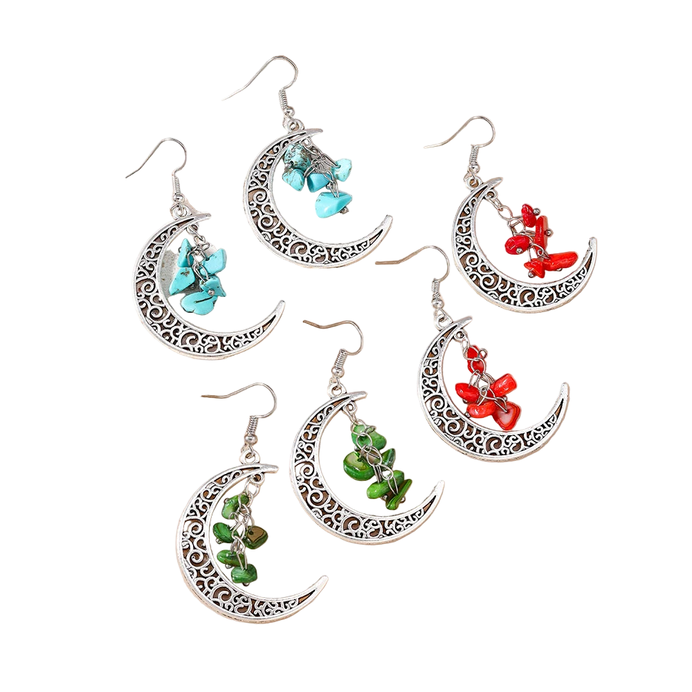 Set of moon-shaped earrings with turquoise, red, and green stones on a beige background.