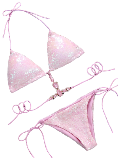 pink sequined bikini featuring a halter-style top. It has sparkling crystal embellishments and a decorative chain detail, adding an elegant and glamorous touch.