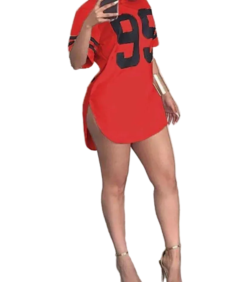 Person wearing a red dress with large black numbers in a room.