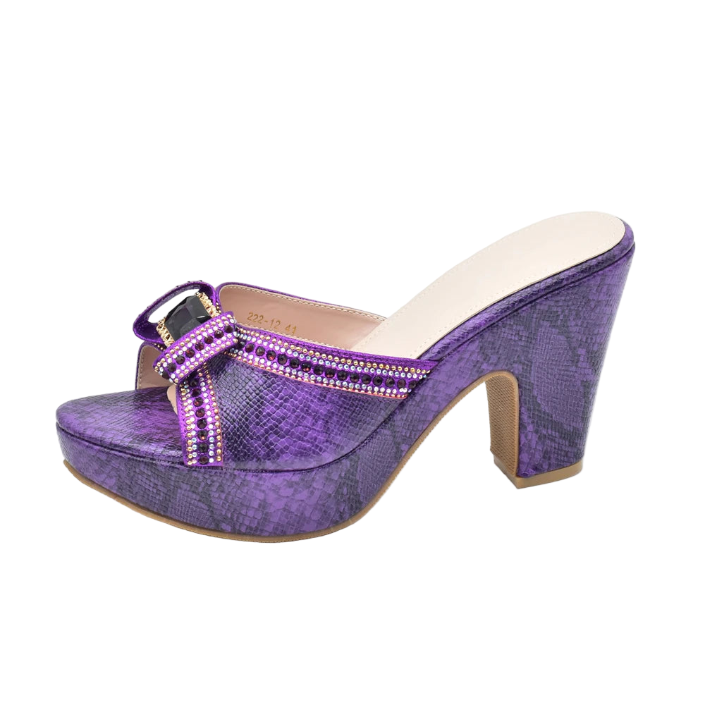 Purple high-heeled shoe with a platform on a white background