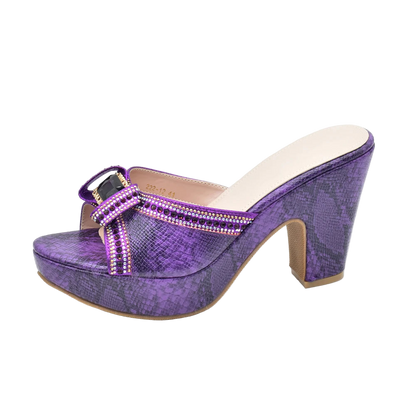 Purple high-heeled shoe with a platform on a white background