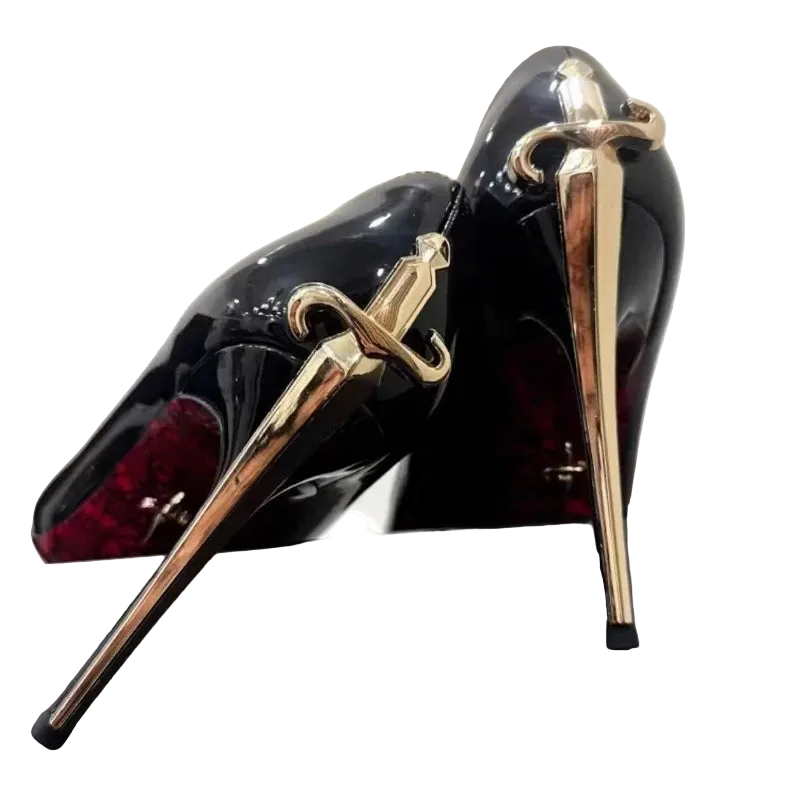 Black high-heeled shoes with gold sword designs on a white background