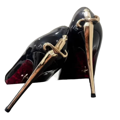 Black high-heeled shoes with gold sword designs on a white background