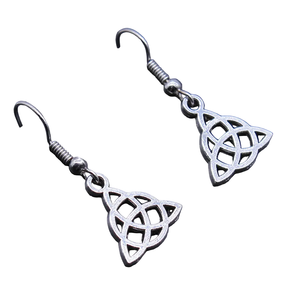 A pair of silver-toned Celtic triquetra dangle earrings with fishhook backings, displayed on a dark textured surface.