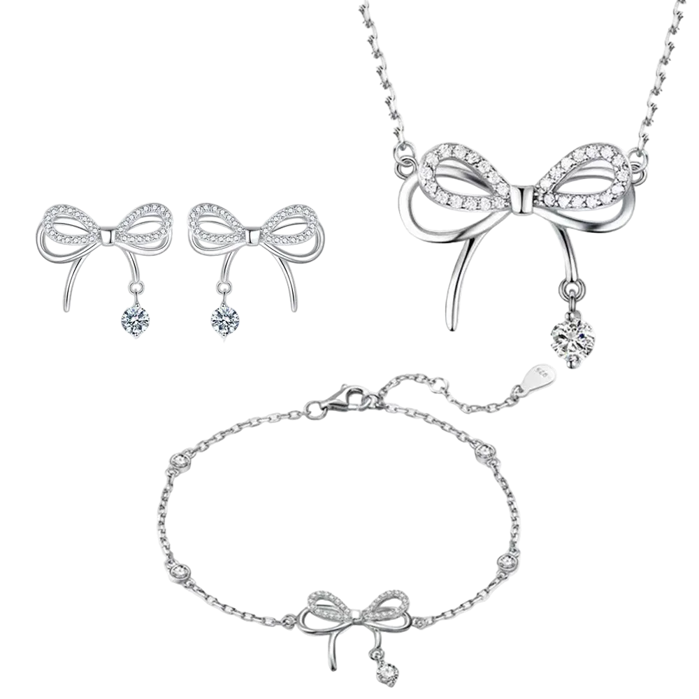 Silver bow-shaped jewelry set including necklace, earrings, and bracelet on a white background