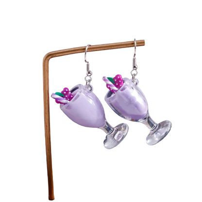 Mimosa glass earrings with pink drink and umbrella on a stand