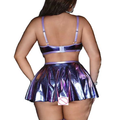 A person shown from the back wearing a shiny iridescent purple and blue two-piece outfit with a bra-style top and pleated mini skirt, standing in front of a dark curtain.