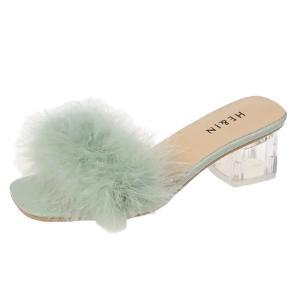 Mint green fluffy slide sandal with clear heel on a white background
