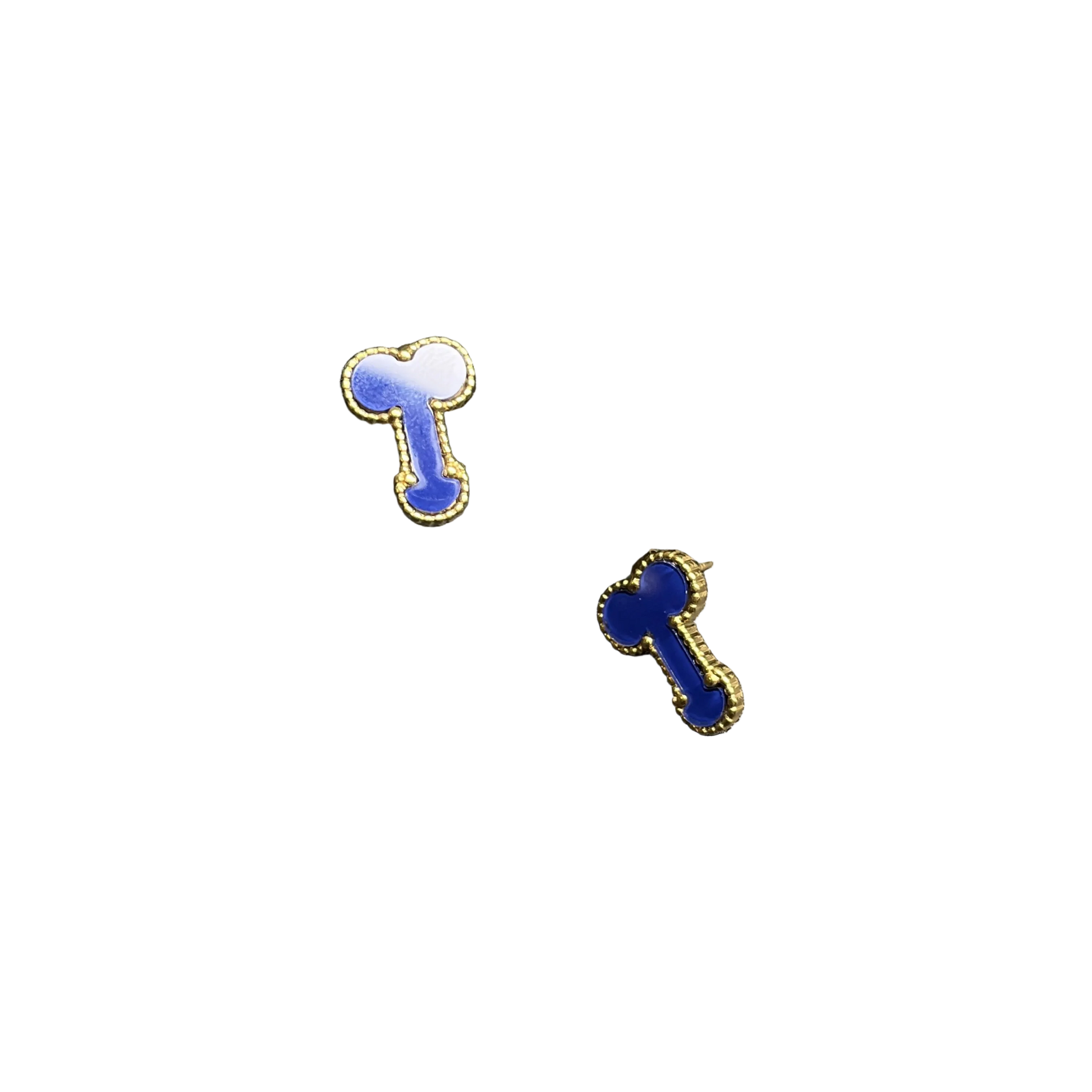 Two small bone-shaped stud earrings with blue enamel and gold-tone edges, displayed on a dark textured surface with one earring resting on a black rectangular stand.