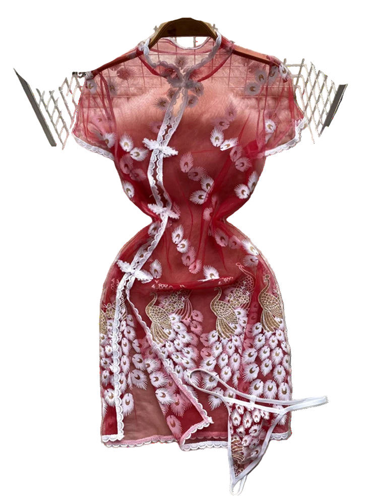 Red lace dress on a white fur surface with floral decorations in the background