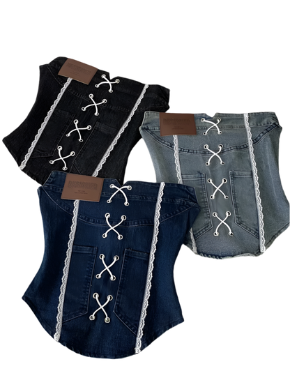 Denim dog outfit with lace details on a white surface