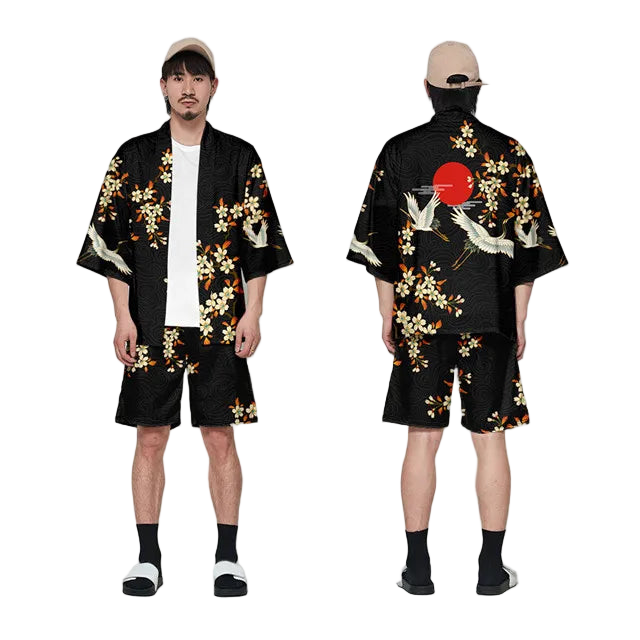 Person wearing a black kimono with floral and crane designs, standing against a white background.