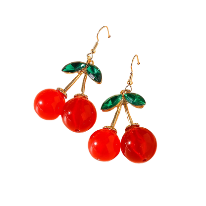 Cherry-themed earrings on a beige background