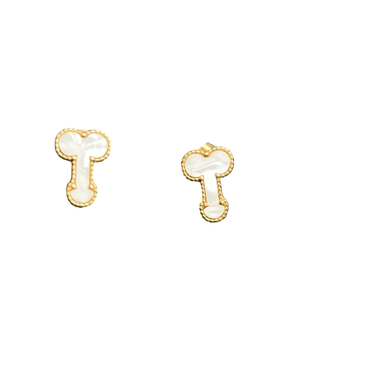 A pair of small gold-tone stud earrings with white enamel details, displayed on a textured black surface.