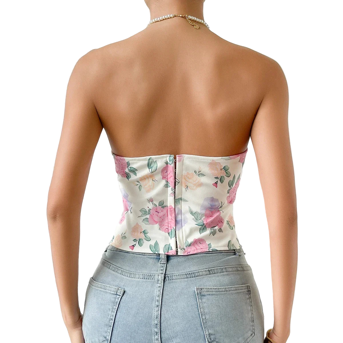 Person wearing a floral strapless top and denim shorts against a white background