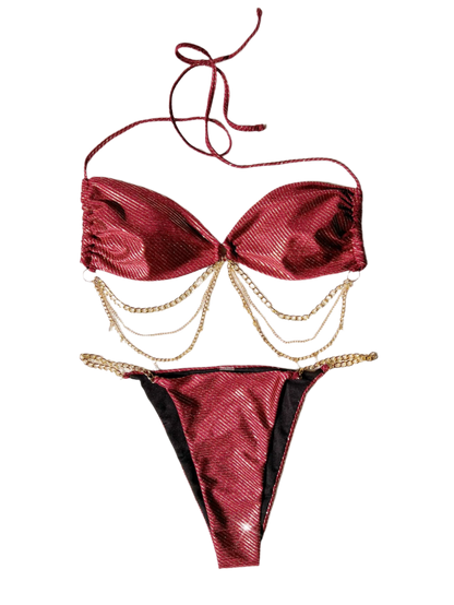 A glamorous red bikini with a metallic sheen, adorned with gold chain embellishments. The set includes a bandeau top and matching bottoms, offering a luxurious and stylish appearance.