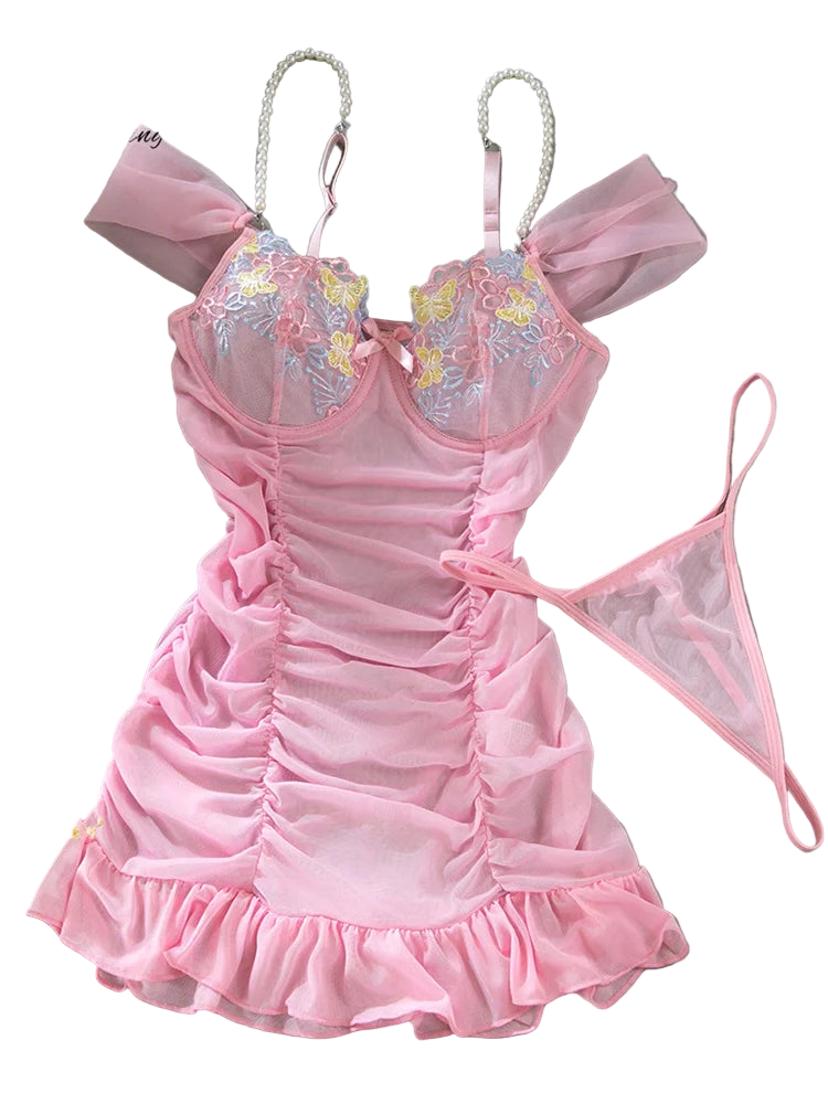 Pink lingerie set with floral embroidery on a gray surface