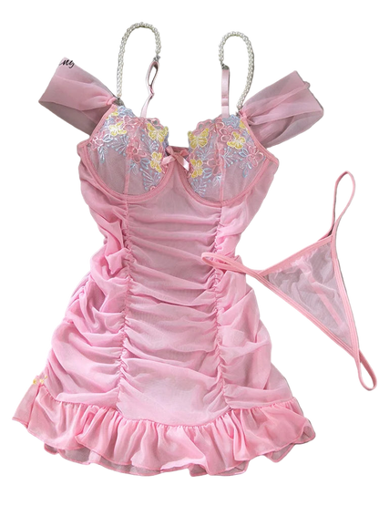 Pink lingerie set with floral embroidery on a gray surface