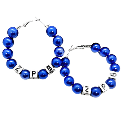 Blue beaded bracelets with letter charms on a black textured surface