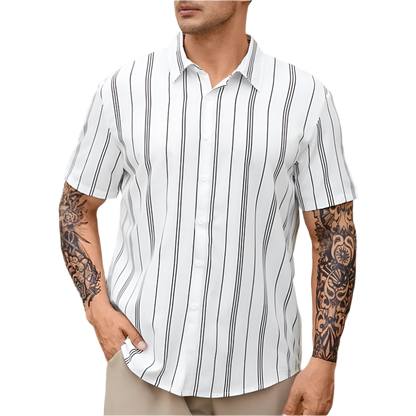 Man wearing a white short-sleeve shirt with black vertical stripes, standing outdoors.